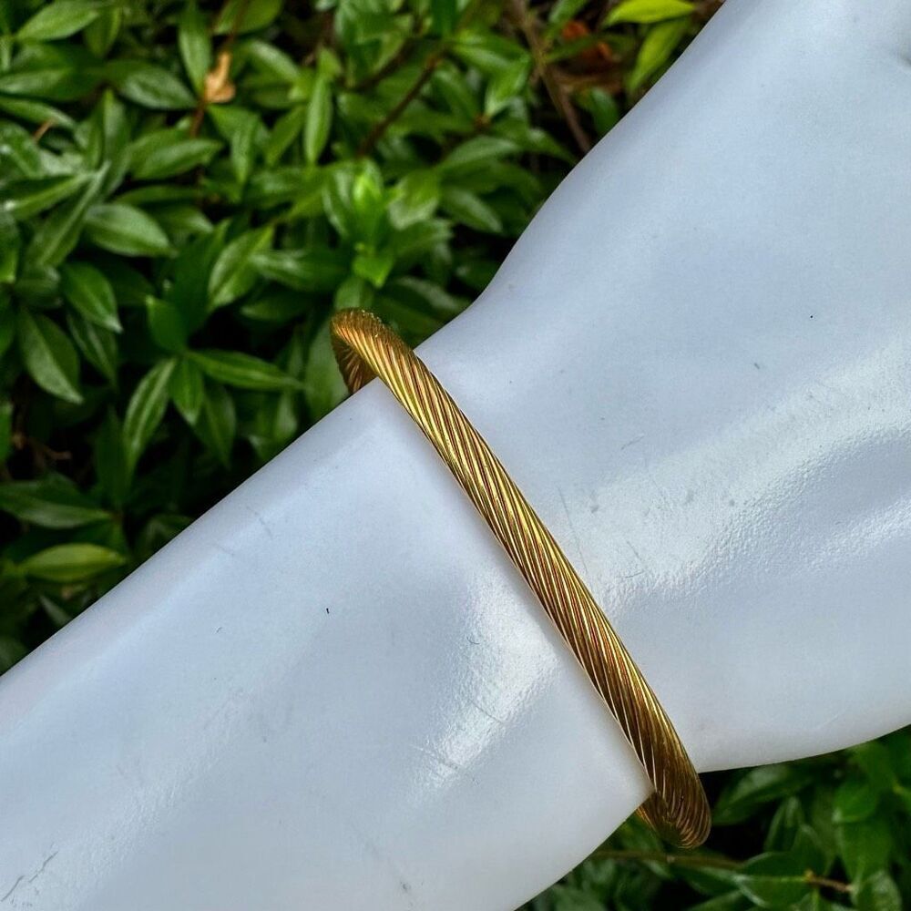 Gold tone twisted magnetic open bangle bracelet